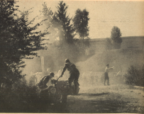 Photo - Dusty fume and stony boulder give a clear image of the arduousness of this six days trial. The moves of the people reflect the stress, which the riders have all day long. The two with #239 led by F Weber BMW 593 from the Kraftfahrtschule der Luftwaffe [Air Force motoring school], in the foreground of the picture, have won some time [in advance of the schedule], which they now use for some smaller work. ISDT 1939 (das Motorrad)