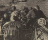 Photo – Sometimes it became very tough, and this picture shows, how Korpsführer Hühnlein [Head of the NSKK] himself gives a hand to help a stuck sidecar outfit. The rider is DDAC [Der Deutsche Automobil Club – the German Automobile Club] man #29 Schrimpf on the BMW R 17 outfit. ISDT 1939 (das Motorrad)